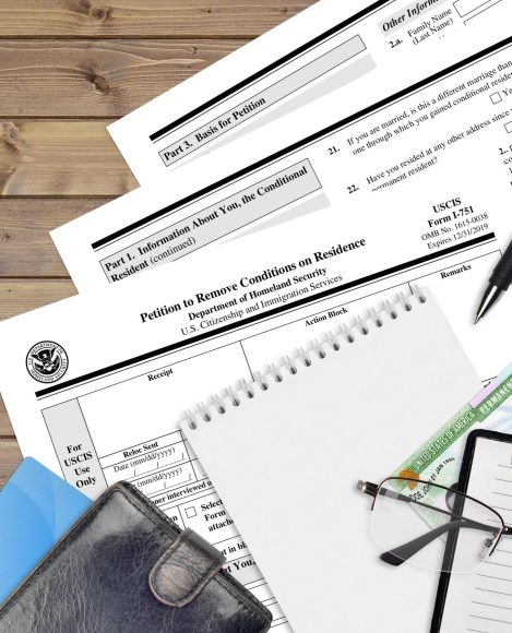 USCIS form I-751 Petition to remove conditions on residence lies on flat lay office table and ready to fill. U.S. Citizenship and Immigration services paperwork concept. Top view